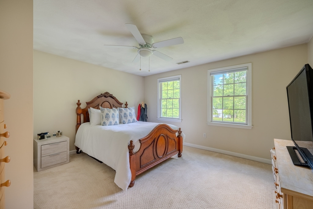 64 Jacques Road Tyngsboro, MA 01879 - Photo 24 of 39 a bed sitting in a bedroom next to a window