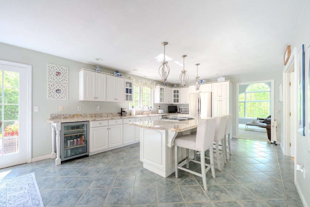 64 Jacques Road Tyngsboro, MA 01879 - Photo 3 of 39 a kitchen with a white cabinets and chairs