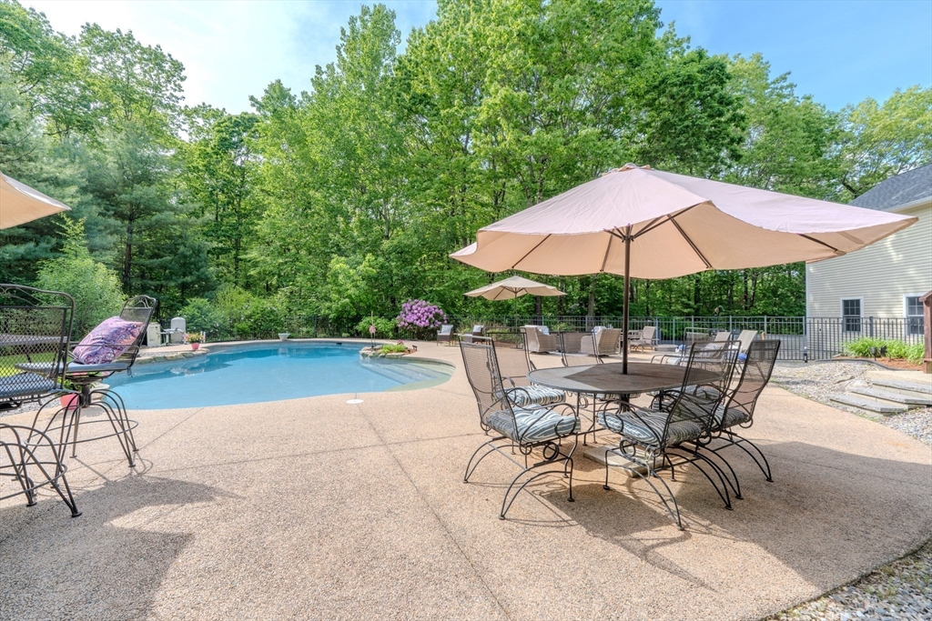 64 Jacques Road Tyngsboro, MA 01879 - Photo 38 of 39 a patio with a patio table and chairs