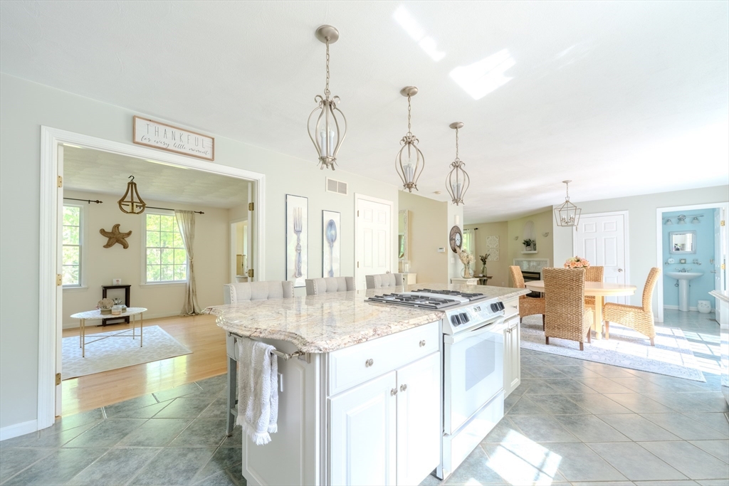 64 Jacques Road Tyngsboro, MA 01879 - Photo 4 of 39 a dining hall with stainless steel appliances kitchen island granite countertop a sink and cabinets