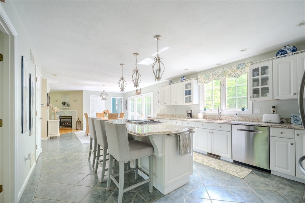 64 Jacques Road Tyngsboro, MA 01879 - Photo 5 of 39 a kitchen with center island table and chairs