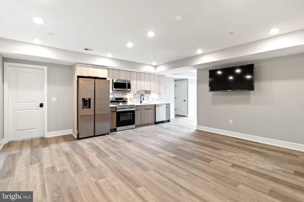 a kitchen with stainless steel appliances a refrigerator sink and microwave