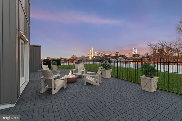 a roof deck with table and chairs