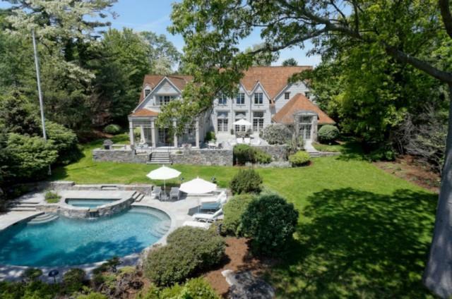 a view of a house with swimming pool and sitting area