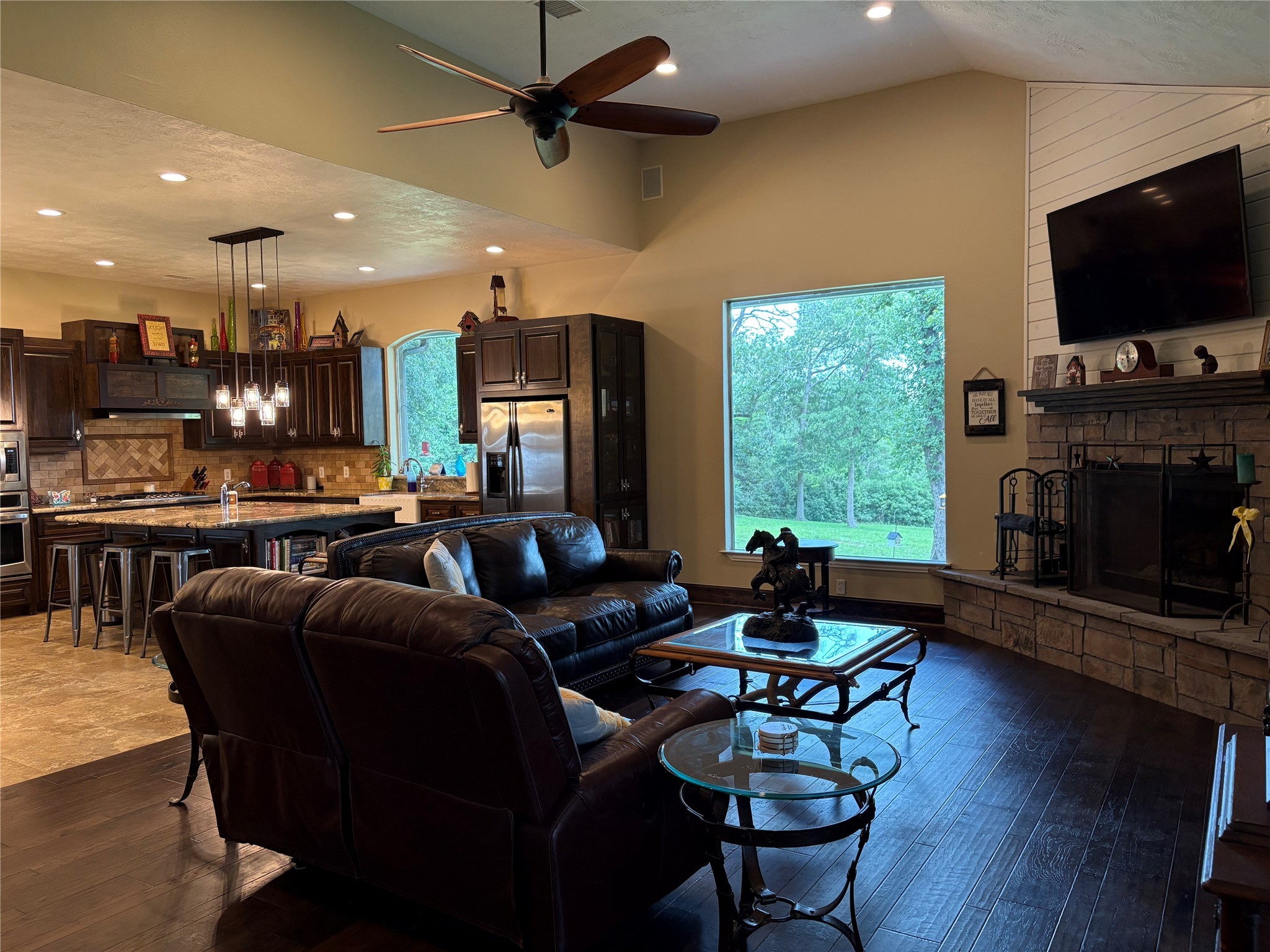 8595 Jared Road Bellville, TX 77418 - Photo 15 of 30 a living room with fireplace furniture and a flat screen tv