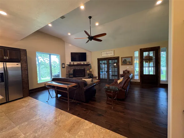 a living room with furniture a fireplace and a flat screen tv