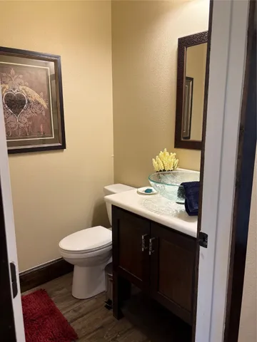a bathroom with a sink toilet and mirror