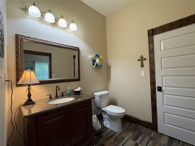 a bathroom with a toilet sink and mirror