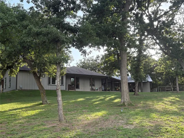 a view of a house with a tree in a yard