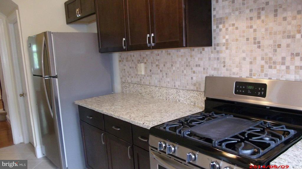 3712 Kimble Road Baltimore, MD 21218 - Photo 11 of 30 a stove top oven sitting inside of a kitchen