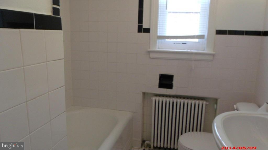 3712 Kimble Road Baltimore, MD 21218 - Photo 17 of 30 a bathroom with a bathtub and a window