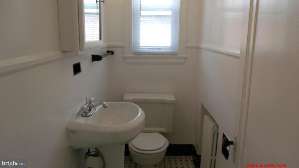 3712 Kimble Road Baltimore, MD 21218 - Photo 18 of 30 a bathroom with a sink a toilet and a window