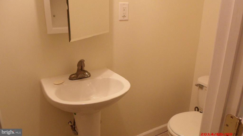 3712 Kimble Road Baltimore, MD 21218 - Photo 24 of 30 a bathroom with a sink a toilet and mirror