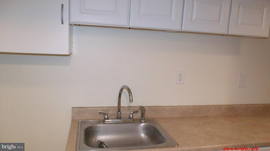 3712 Kimble Road Baltimore, MD 21218 - Photo 26 of 30 a bathroom with a sink and cabinets