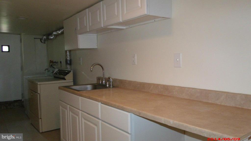3712 Kimble Road Baltimore, MD 21218 - Photo 28 of 30 a bathroom with a sink and cabinets