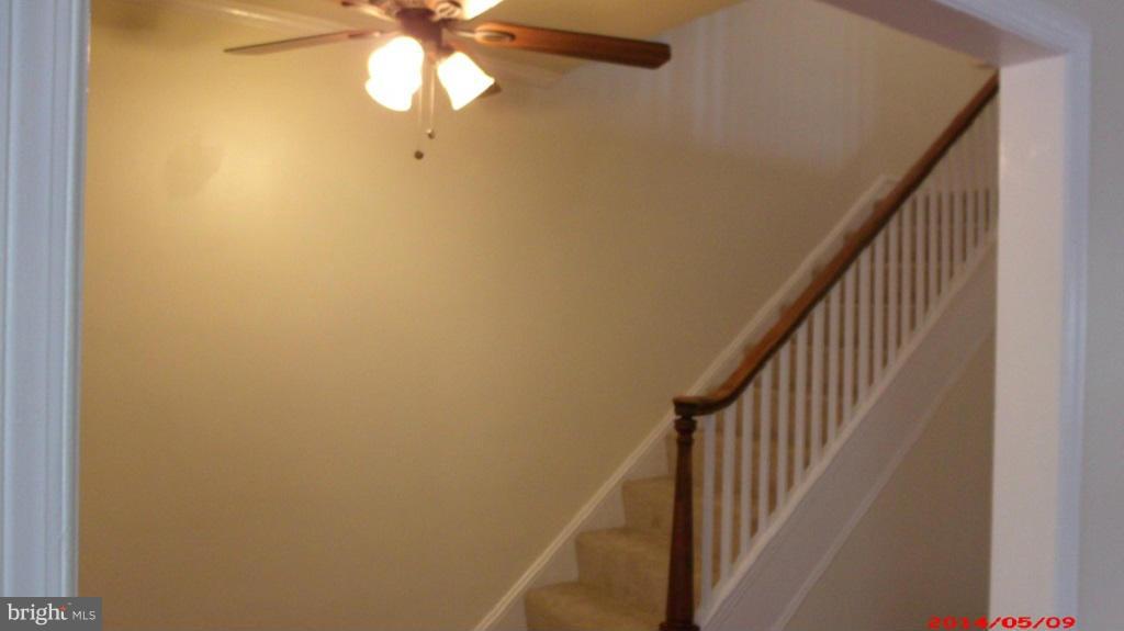 3712 Kimble Road Baltimore, MD 21218 - Photo 4 of 30 a view of staircase with wooden floor and fan