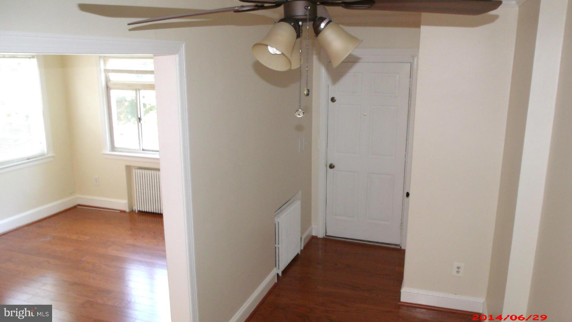 3712 Kimble Road Baltimore, MD 21218 - Photo 5 of 30 a view of hallway with a large window and wooden floor