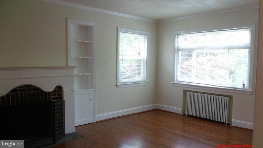 3712 Kimble Road Baltimore, MD 21218 - Photo 6 of 30 a view of an empty room with wooden floor and a window
