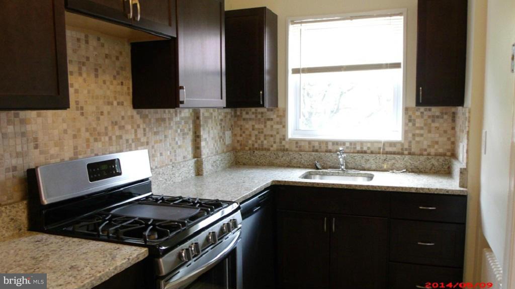 3712 Kimble Road Baltimore, MD 21218 - Photo 10 of 30 a kitchen with stainless steel appliances a sink stove and cabinets