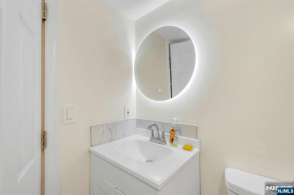 331 1/2 Forest Street Kearny, NJ 07032 - Photo 11 of 17 a bathroom with a sink and a mirror