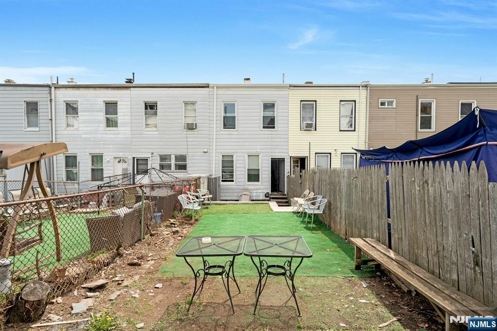 331 1/2 Forest Street Kearny, NJ 07032 - Photo 16 of 17 a view of a patio with table and chairs and potted plants