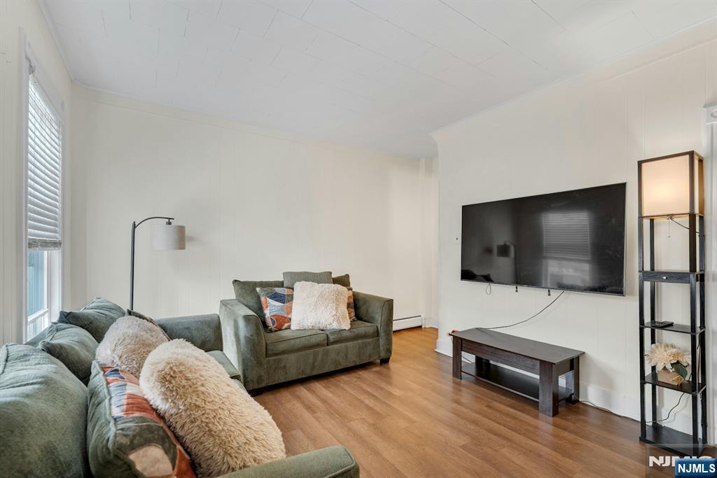 331 1/2 Forest Street Kearny, NJ 07032 - Photo 2 of 17 a living room with furniture and a flat screen tv