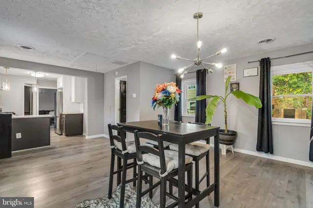 a view of a dining room with furniture and a chandelier