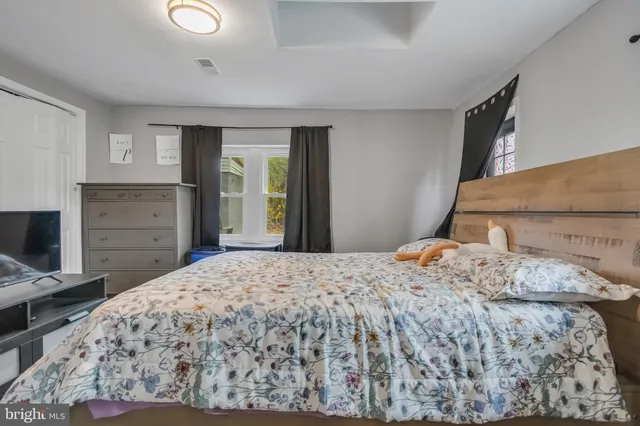 a bedroom with a bed and a dresser