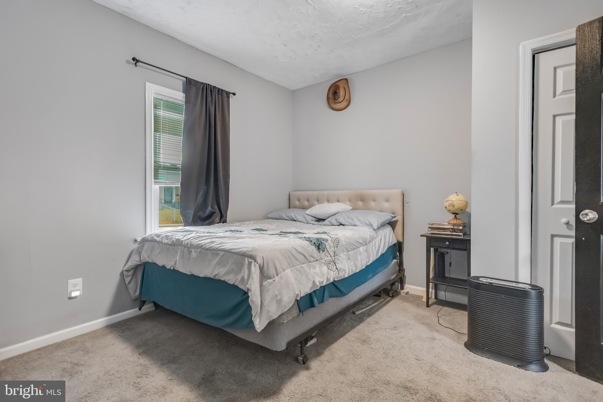 1101 51st Place Northeast Washington, DC 20019 - Photo 21 of 25 a bedroom with a bed and a window