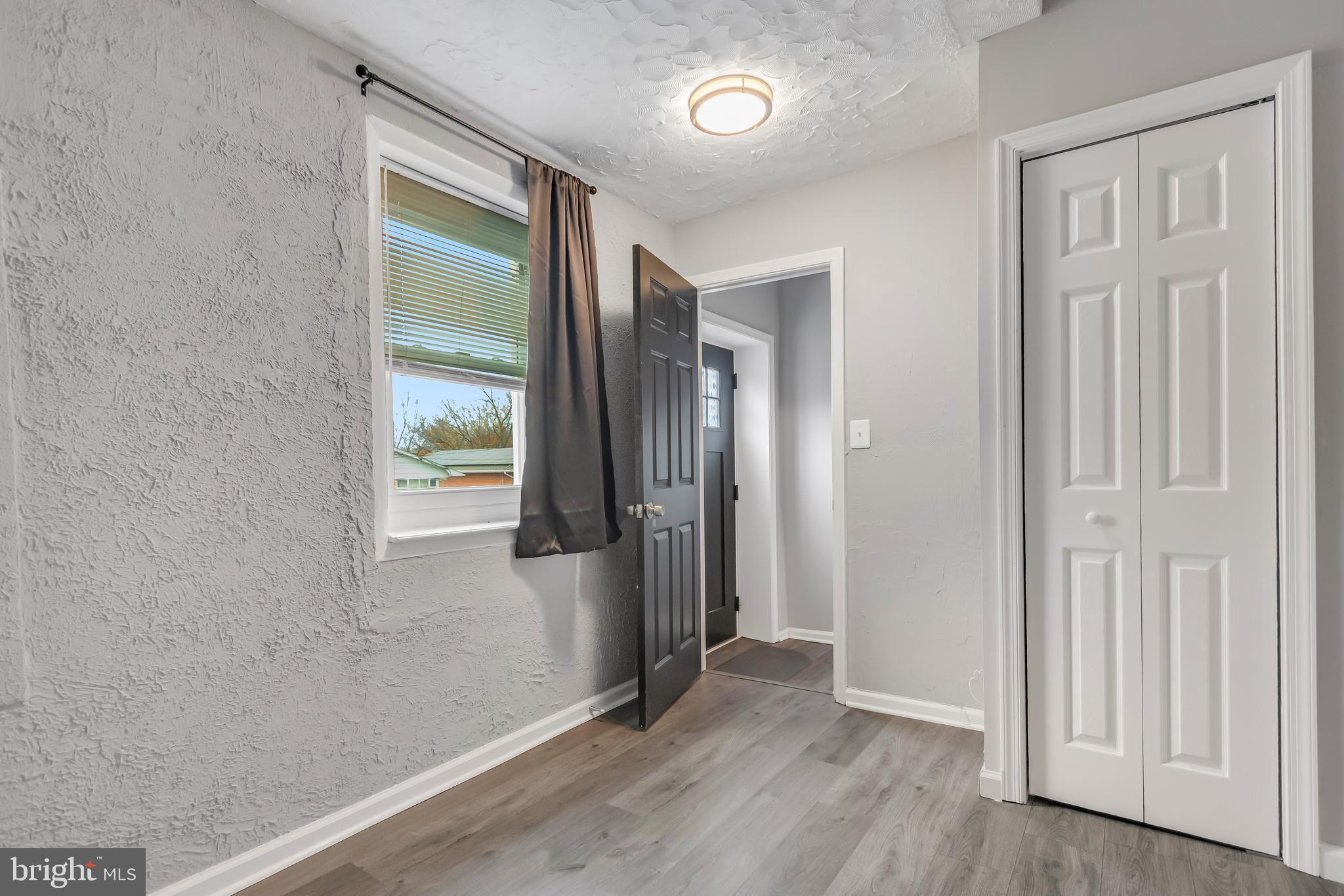1101 51st Place Northeast Washington, DC 20019 - Photo 24 of 25 an empty room with wooden floor and a window