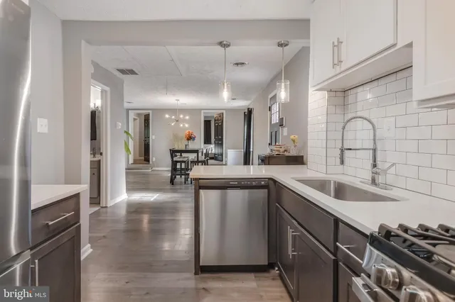 a kitchen with stainless steel appliances granite countertop a sink and stove