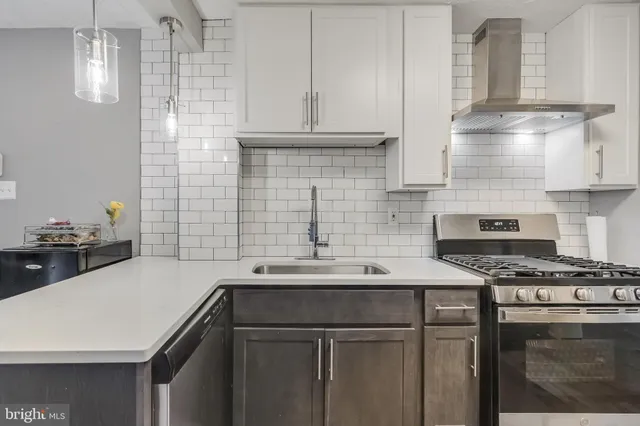 a kitchen with a sink a stove and cabinets