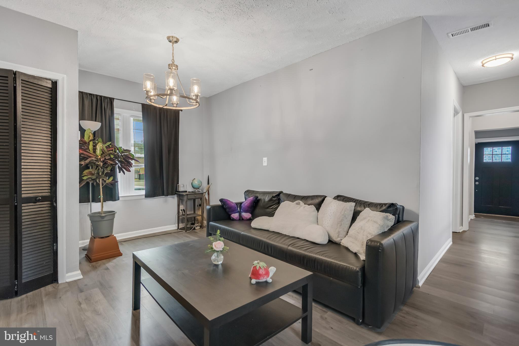1101 51st Place Northeast Washington, DC 20019 - Photo 7 of 25 a living room with furniture and a chandelier