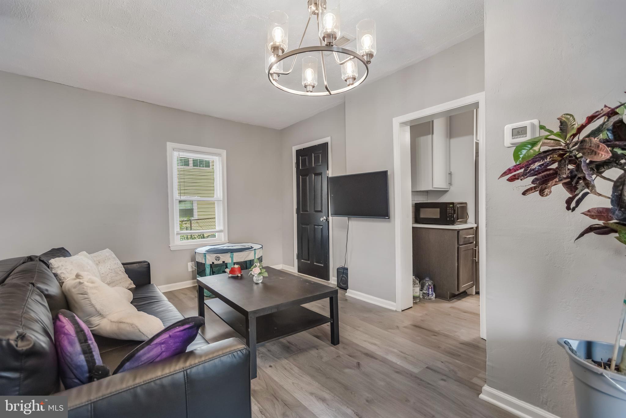 1101 51st Place Northeast Washington, DC 20019 - Photo 8 of 25 a living room with furniture a chandelier and a dining room