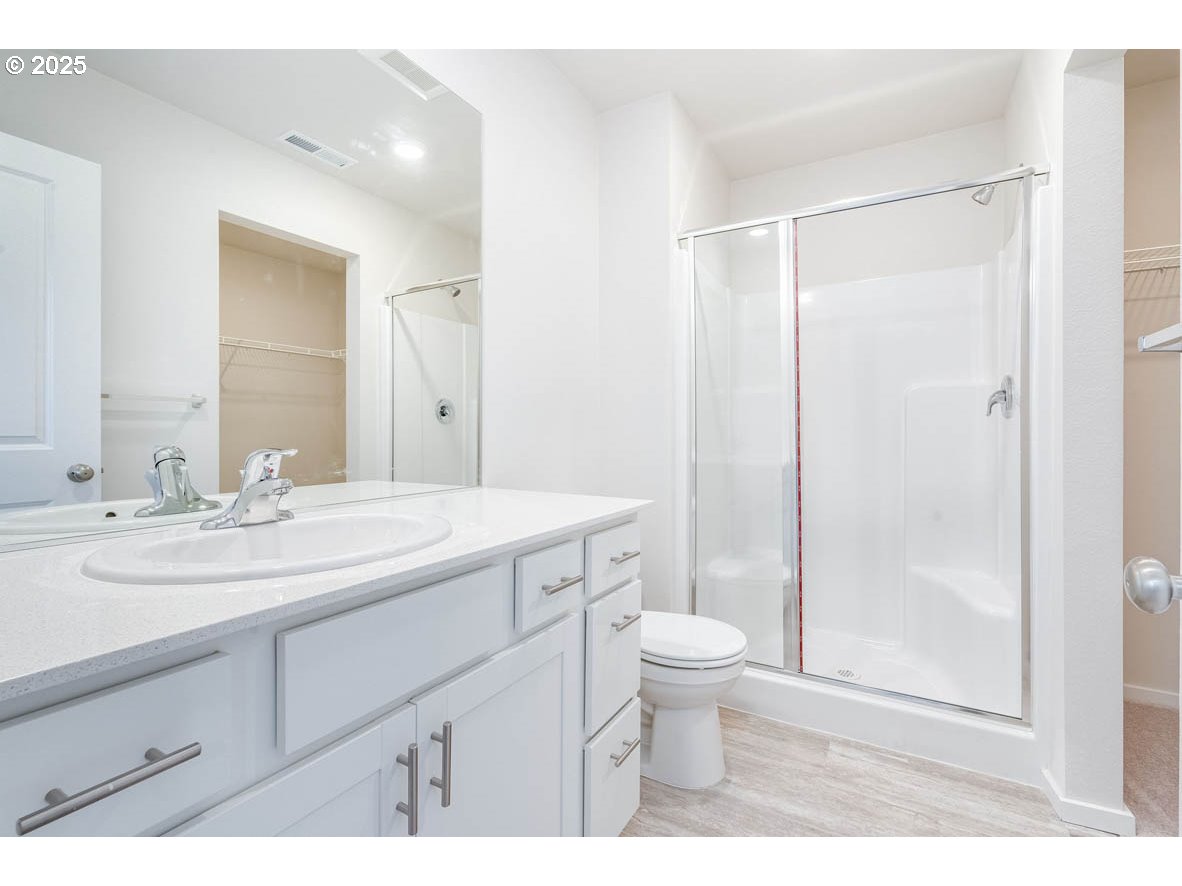 2983 T Street Springfield, OR 97477 - Photo 13 of 16 a bathroom with a sink a toilet a shower and a mirror