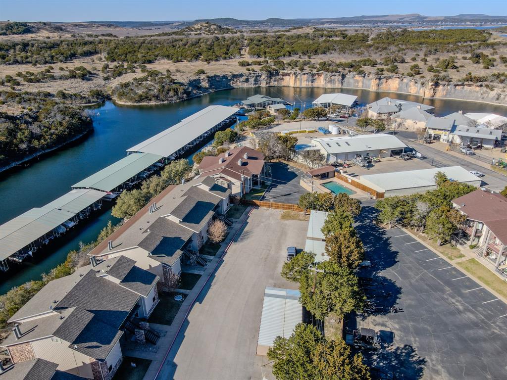 3037 Hells Gate Loop, Unit C208 Strawn, TX 76475 - Photo 24 of 24 an aerial view of residential houses with outdoor space