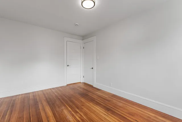 a view of a room with wooden floor