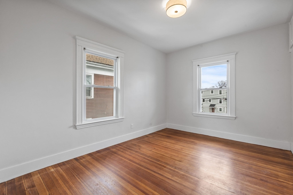 16 Clarkwood Street, Unit 2 Boston, MA 02126 - Photo 17 of 34 a view of an empty room with wooden floor and a window