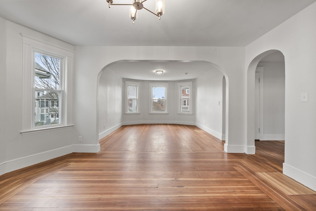 16 Clarkwood Street, Unit 2 Boston, MA 02126 - Photo 6 of 34 a view of an empty room with wooden floor and a window