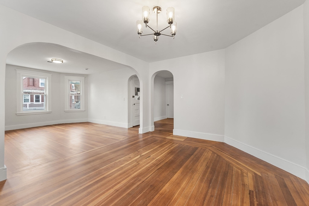 16 Clarkwood Street, Unit 2 Boston, MA 02126 - Photo 8 of 34 a view of an empty room with a window and wooden floor