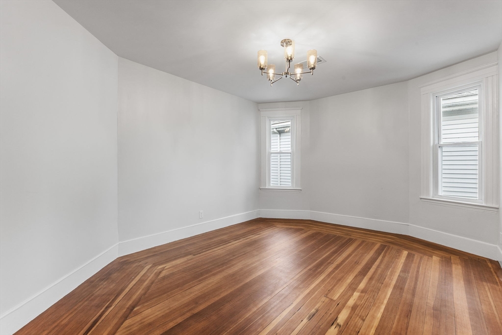 16 Clarkwood Street, Unit 2 Boston, MA 02126 - Photo 9 of 34 a view of an empty room with wooden floor and a window