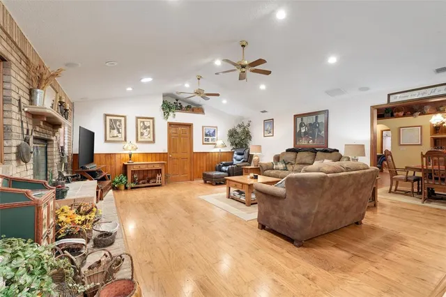 a large kitchen with granite countertop a sink stainless steel appliances and cabinets