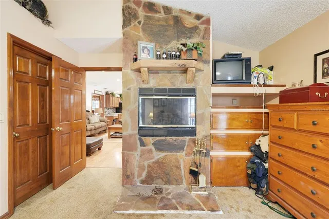 a bedroom with a bed a window and dresser