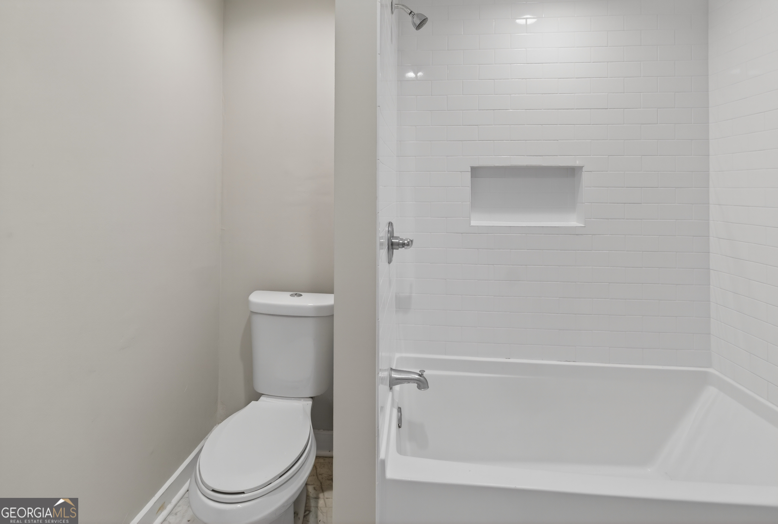 49 Milner Street Temple, GA 30179 - Photo 19 of 32 a white toilet sitting next to a shower