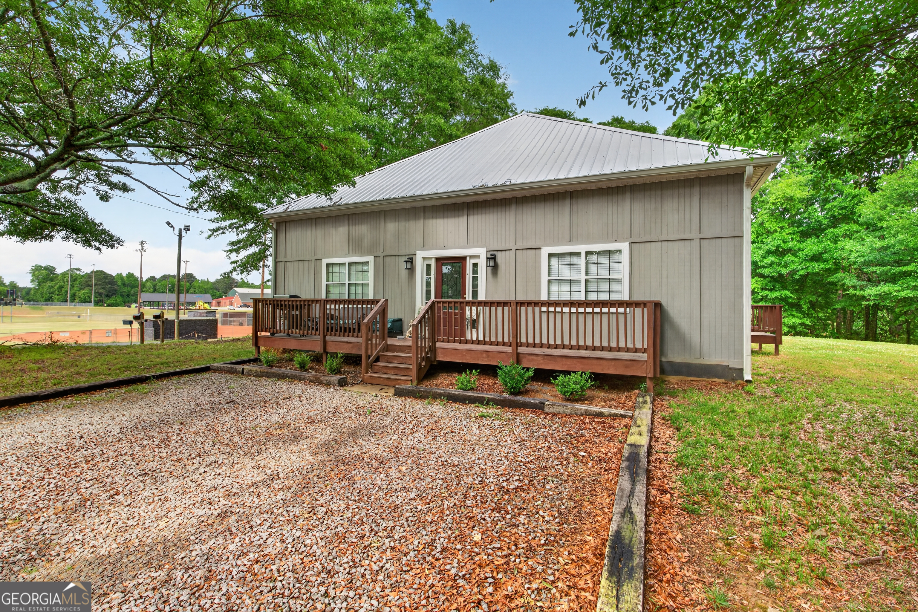 49 Milner Street Temple, GA 30179 - Photo 28 of 32 a backyard of a house with barbeque oven table and chairs
