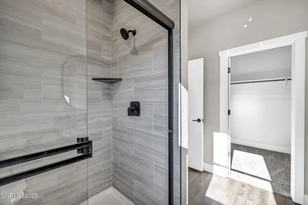 a bathroom with a shower and a glass door