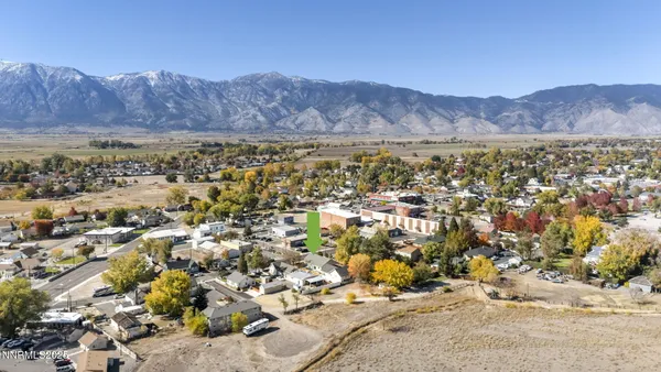 an aerial view of residential house and sandy dunes