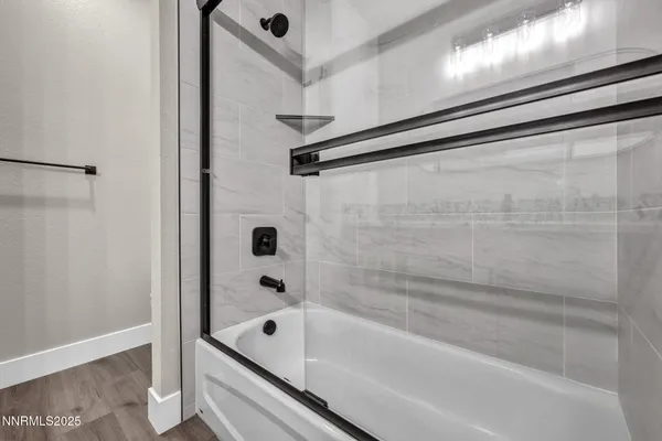 a bathroom with a tub and shower