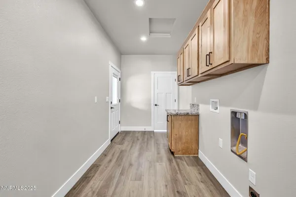 a view of a kitchen with wooden floor and cabinets