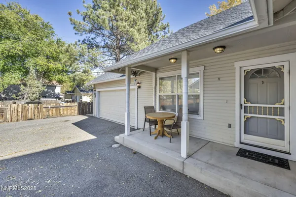 a view of a house with backyard and sitting area